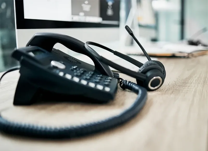 Phone and headset at office cubical of a call center